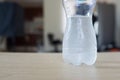 Half empty bottle of fresh water with drops Royalty Free Stock Photo