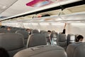 Half empty cabin of a passenger plane. Empty seats for passengers. Airplane interior