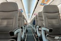 Half empty cabin of a passenger plane. Empty seats for passengers. Airplane interior