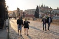 Half-empty Charles Bridge in Prague during coronavirus pandemic, with people wearing face masks