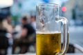 Half empty glass of light beer in a pub. Selective focus Royalty Free Stock Photo