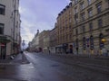 Half empty streets of old Riga after rain. View of the carriageway and cobblestone pavement.