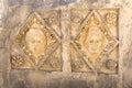 Half-erased stone-cut masks on the ruins of a building in the ancient city of Mira, Turkey Royalty Free Stock Photo