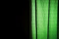 Exposed green curtain on a black background Royalty Free Stock Photo