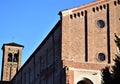 Half of the facade of the church of the Eremitani and the bell tower in the sun, the left side in the shade, with the background o Royalty Free Stock Photo