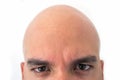 Half face of bald man in white background. Closeup of the eyes. Royalty Free Stock Photo