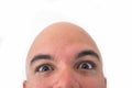 Half face of bald man in white background. Closeup of the eyes. Royalty Free Stock Photo