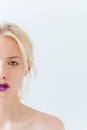 Half face of beautiful young woman with purple stylish makeup Royalty Free Stock Photo