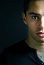 Half face portrait of one serious young man