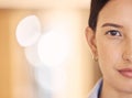 Half face, power and woman or model, serious and vision for success over bokeh background. Portrait of a female facial