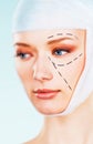 Half face of a woman prepared for surgery correction lines drawn half blur image Royalty Free Stock Photo