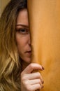 Half face of a young charming girl hidden behind a curtain Royalty Free Stock Photo
