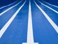 A half filled olympic swimming pool with the bottom painted blue and the lines of the alleys in white, vanishing lines composition Royalty Free Stock Photo