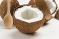 Half a fresh coconut. Wooden spoon. Coconut shells