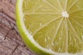 Half of fresh juicy lime on background wooden table Royalty Free Stock Photo