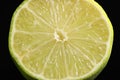 Half of fresh lime on black background, closeup Royalty Free Stock Photo