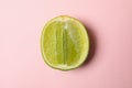 Half of fresh lime on pink background Royalty Free Stock Photo