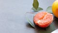 Half a fresh natural grapefruit with leaves and knife Royalty Free Stock Photo