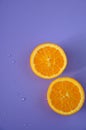 Half of Fresh Orange on Purple Background Royalty Free Stock Photo