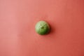 Half fresh ripe green lime on a pink background Royalty Free Stock Photo