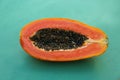 Half of fresh ripe papaya fruit on light blue background Royalty Free Stock Photo