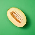 Half of fresh ripe sweet melon on a seagreen background. Royalty Free Stock Photo