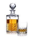 A half full crystal whisky decanter, and crystal glass, with golden whisky, shot on white Royalty Free Stock Photo