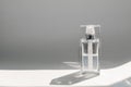 Half-full transparent perfume spray flacon on white background. Selective focus. Copy Space.