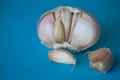 Half of garlic bulb on bright blue background