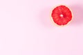 Half grapefruit citrus fruit on pink background Royalty Free Stock Photo