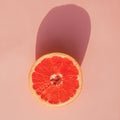 Half of grapefruit isolated on pink background Royalty Free Stock Photo