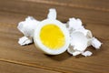 Half a hardboiled egg with the shells laying on the kitchen table