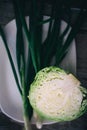 half heads of the fresh white cabbage and peeled stalks of the green onion