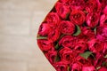 Half image of round big romantic bouquet of red pion-shaped roses