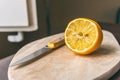 Half lemon and knife on cutting board Royalty Free Stock Photo