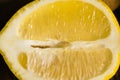 Half of a lemon macro. Juicy tropical fruit on a dark background