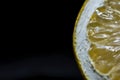 Half lemon slice detail on a black background, close up, isolated Royalty Free Stock Photo