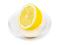 Half lemon on transparent saucer
