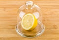 Half lemon in transparent saucer with lid