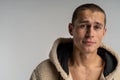 Half lengh portrait of young handsome man in sportwear with short haircut