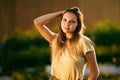 Caucasian woman 26 years old outdoor portrait in light of setting sun in countryside in summer. Royalty Free Stock Photo