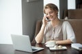 Half-length portrait of happy woman using phone and laptop in ca Royalty Free Stock Photo