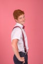 Studio shirt of a  stylish red-haired young smiling redhair man   against  pink background Royalty Free Stock Photo
