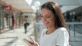 Half length portrait of young businesswoman looking at touch pad screen while standing in modern office space interior Royalty Free Stock Photo