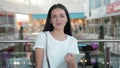 Half length portrait of young businesswoman looking at touch pad screen while standing in modern office space interior Royalty Free Stock Photo