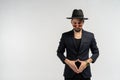 Half length portrait of young handsome serious modern male wearing black suit and hat in round sunglasses Royalty Free Stock Photo