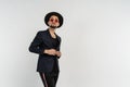 Half length portrait of young handsome serious modern male wearing black suit and hat in round sunglasses Royalty Free Stock Photo