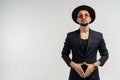 Half length portrait of young handsome serious modern male wearing black suit and hat in round sunglasses Royalty Free Stock Photo