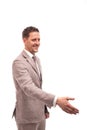 Half length portrait of a young man wearing beige suit , isolated. He welcomes someone to reach out for a handshake Royalty Free Stock Photo