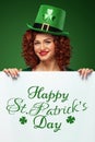 Saint Patrick`s Day. Young Oktoberfest leprechaun, wearing hat with clover on green background with banner for copy Royalty Free Stock Photo